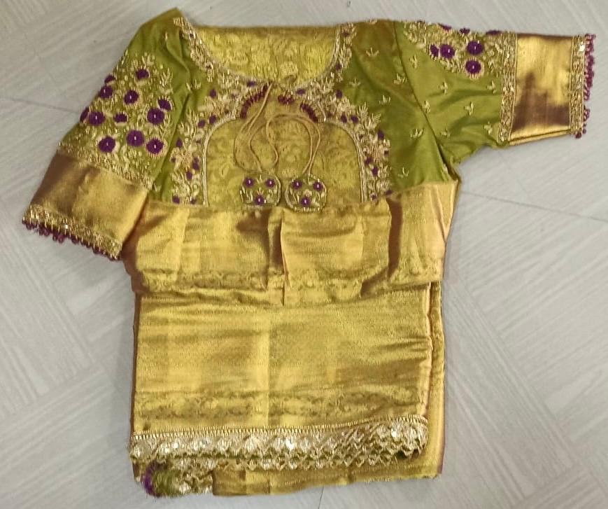 Gold pattu blouse with purple maggam work and ornamental design