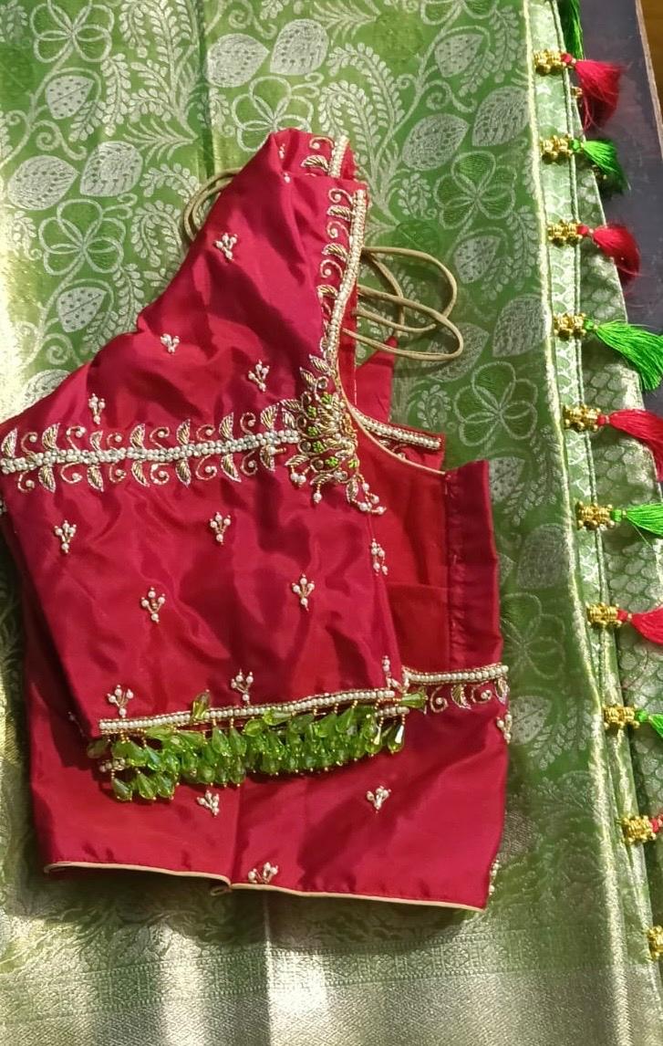 Red bridal blouse with gold zari embroidery and floral threadwork