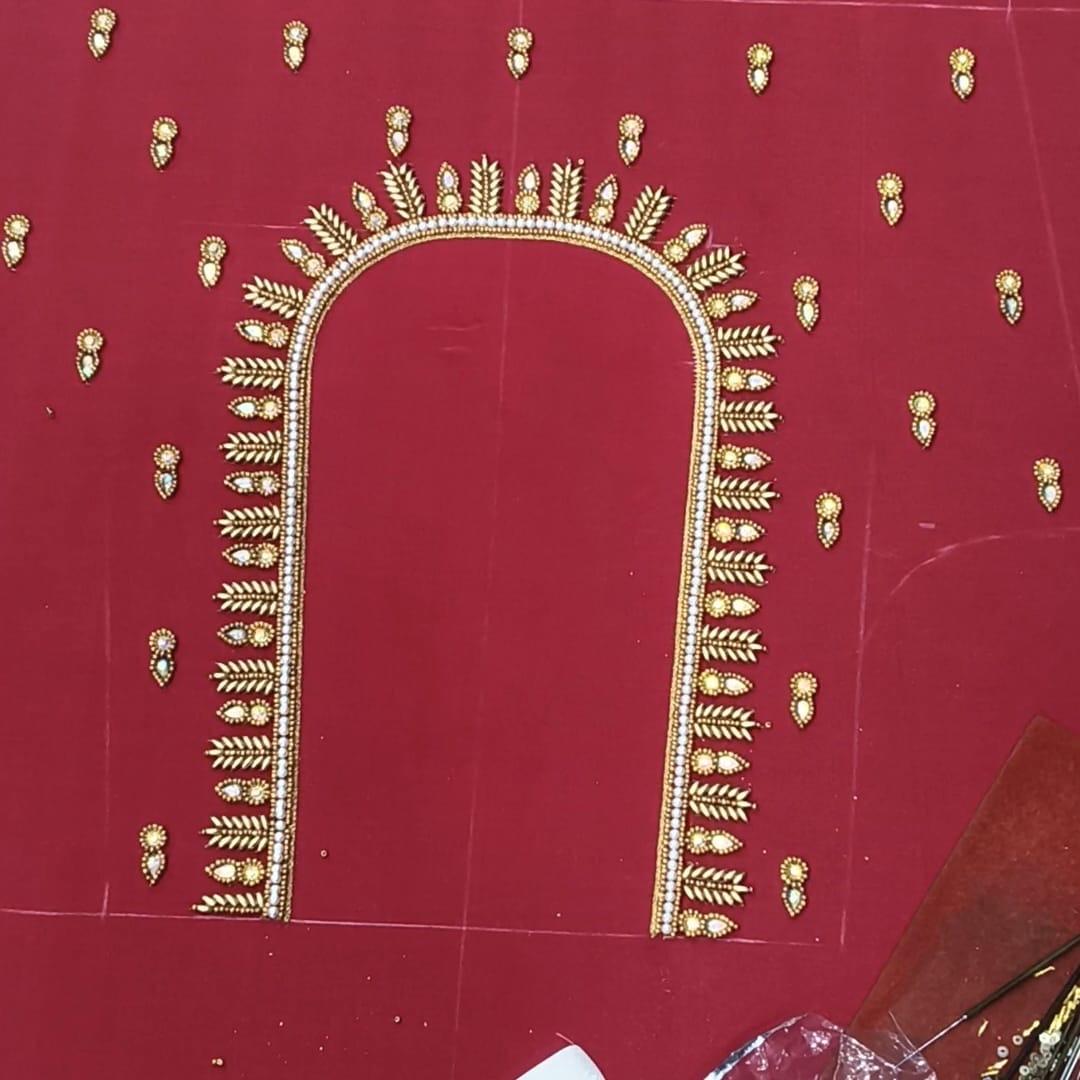 Maroon blouse with gold zari embroidered arch and leaf motifs
