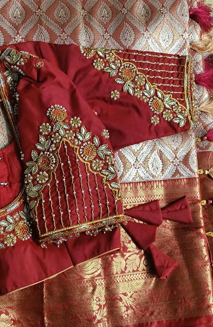 Maroon bridal blouse with gold zari and floral maggam work embroidery