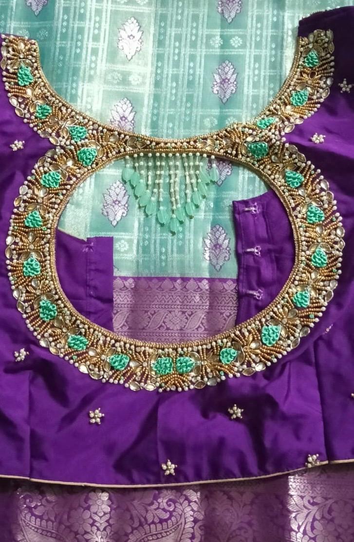 Purple bridal blouse with ornate gold and turquoise maggam work