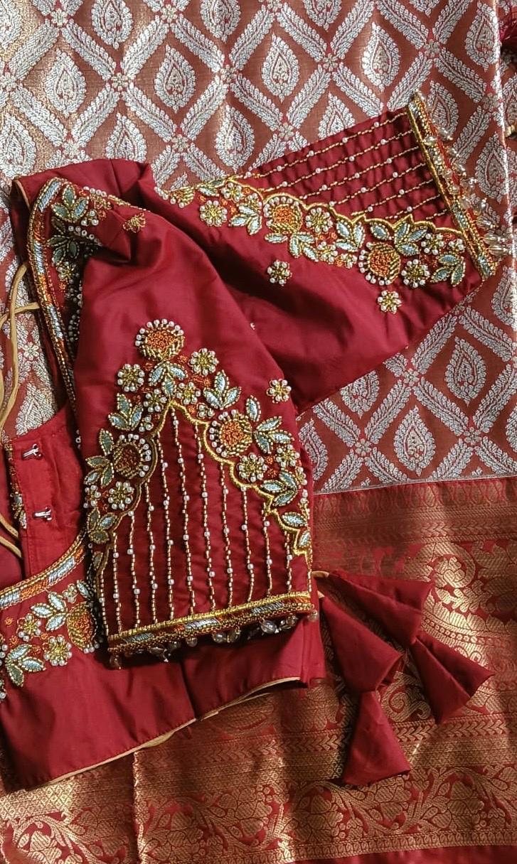 Maroon bridal saree with gold zari embroidery and floral maggam work
