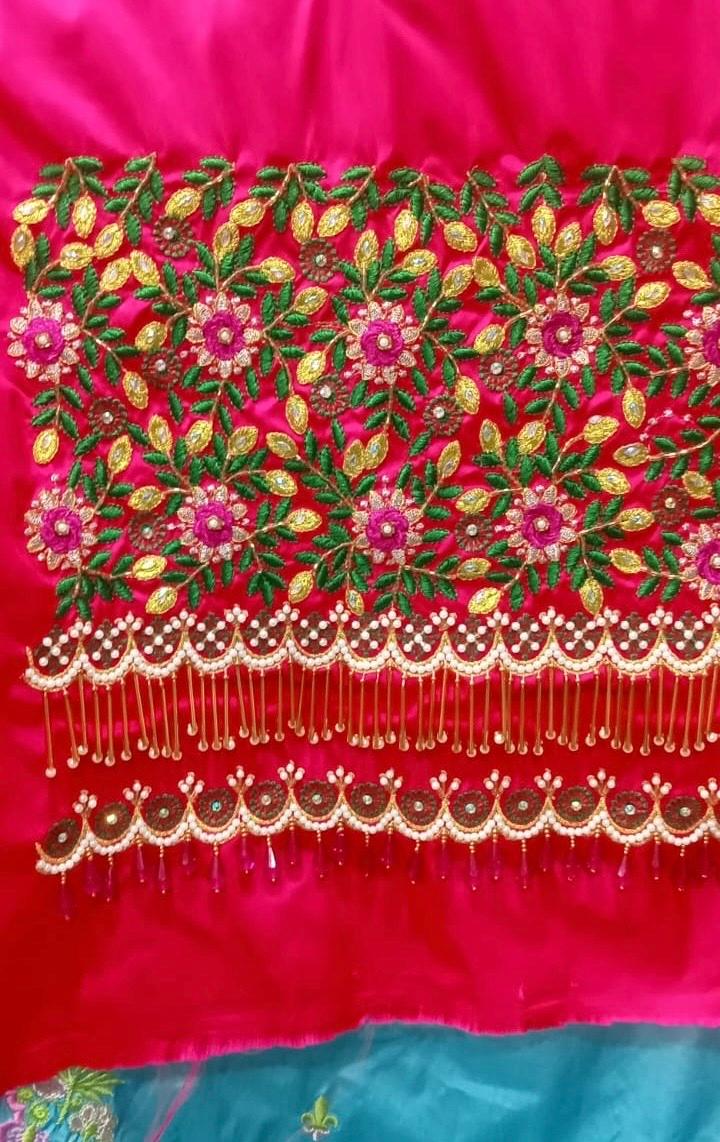 Red bridal blouse with dense floral maggam work and pearl fringe