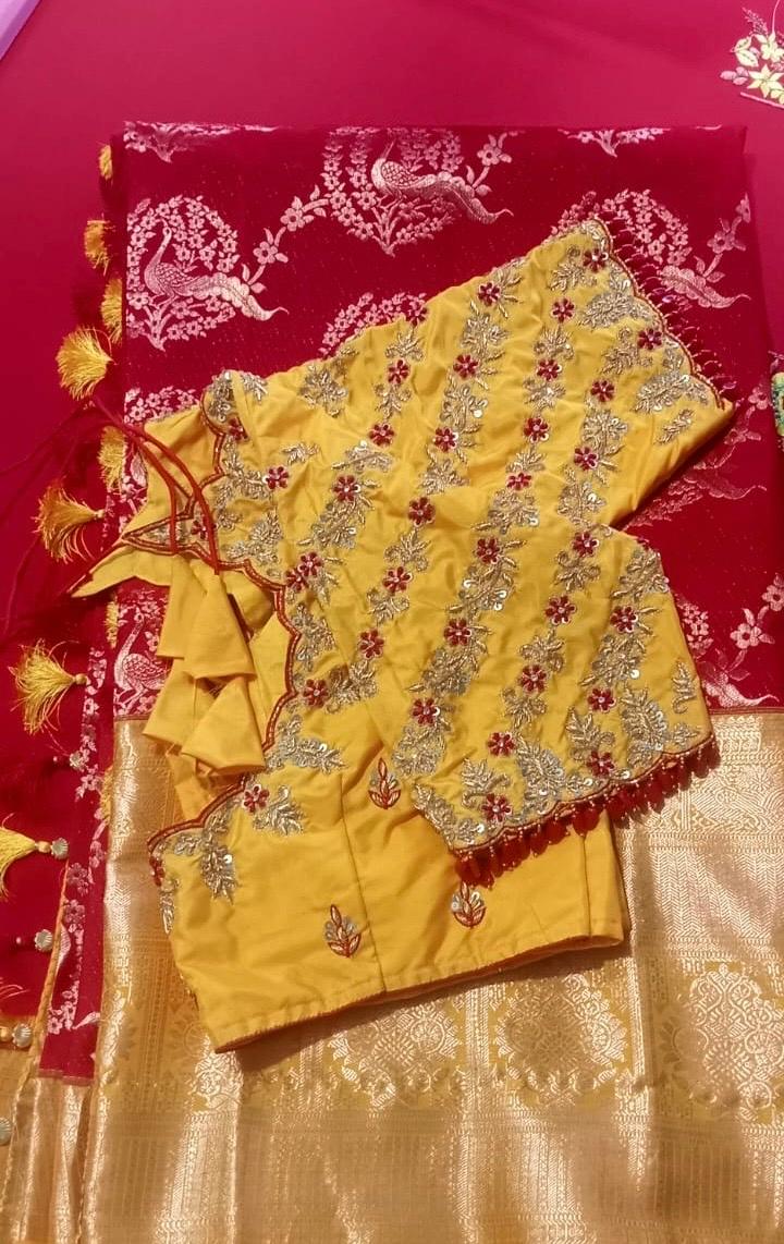 Yellow maggam work blouse with red accents and gold zari embroidery