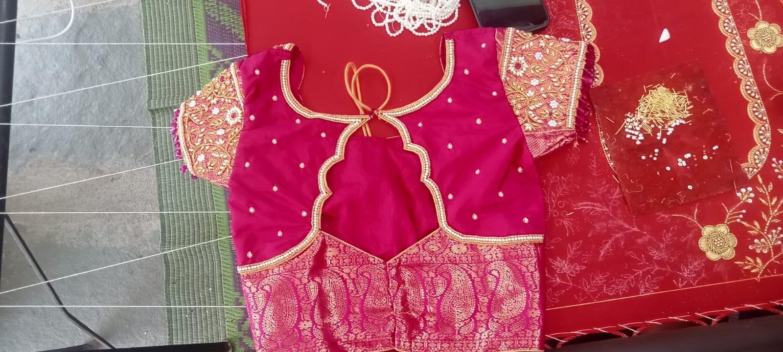 Magenta bridal blouse with gold zari embroidery and pearl embellishments