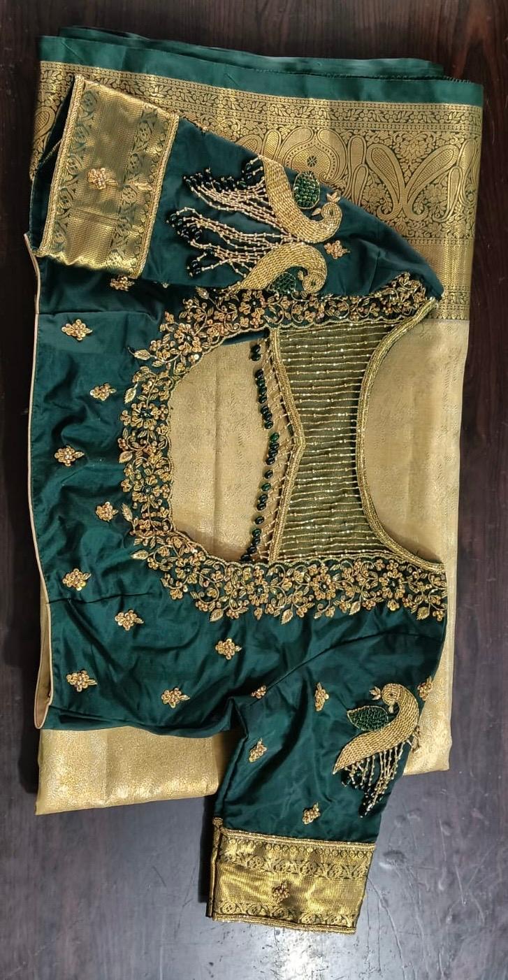 Teal silk saree with gold zari embroidery and peacock motifs