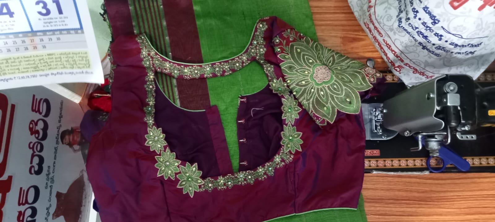 Maroon blouse with green silk panel and gold floral embroidery