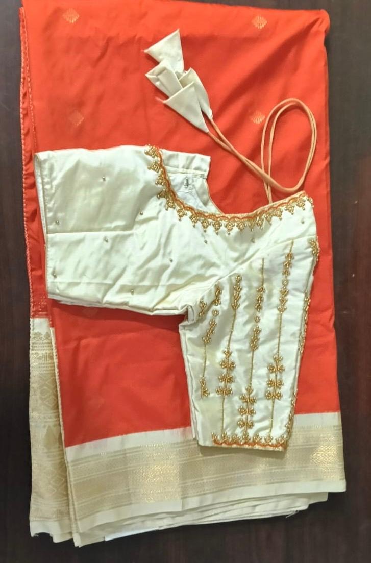 Cream blouse with gold zari embroidery and beaded neckline