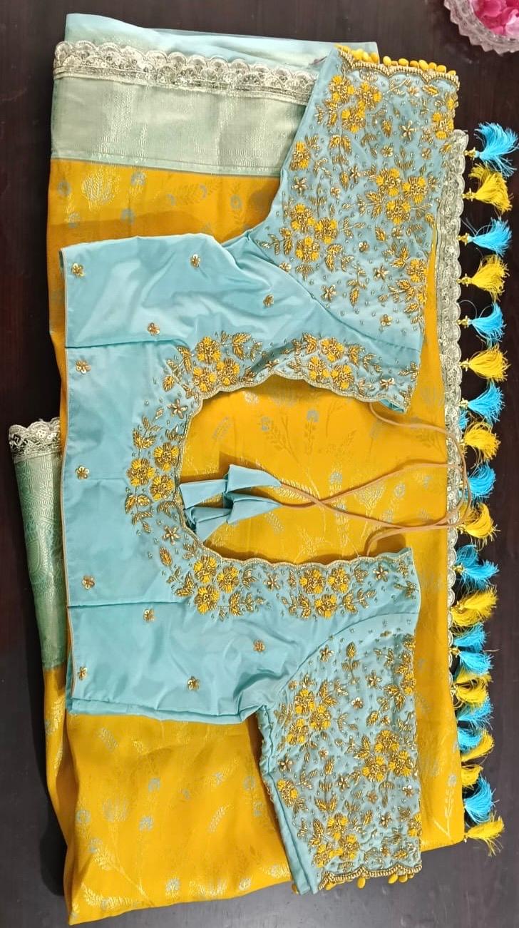 Light blue silk saree with gold zari floral embroidery and lace borders