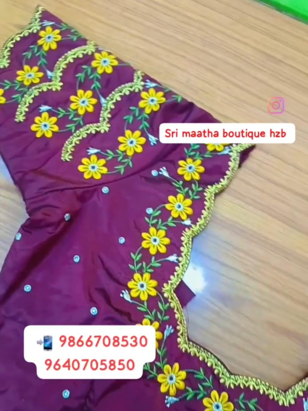 Purple blouse with yellow floral embroidery and gold trim details