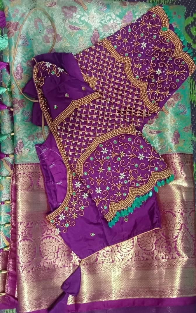 Purple silk saree with gold zari maggam work blouse and ornate borders