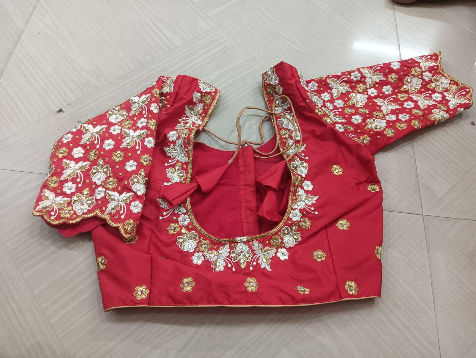 Red bridal blouse with floral embroidery and puffed sleeves