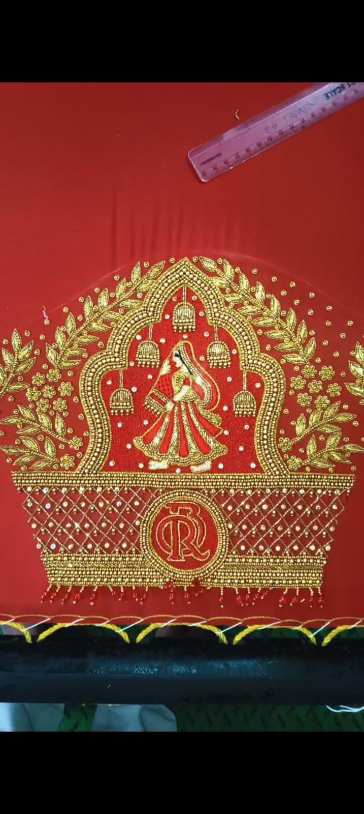 Red silk blouse with gold zari maggam work and traditional motifs