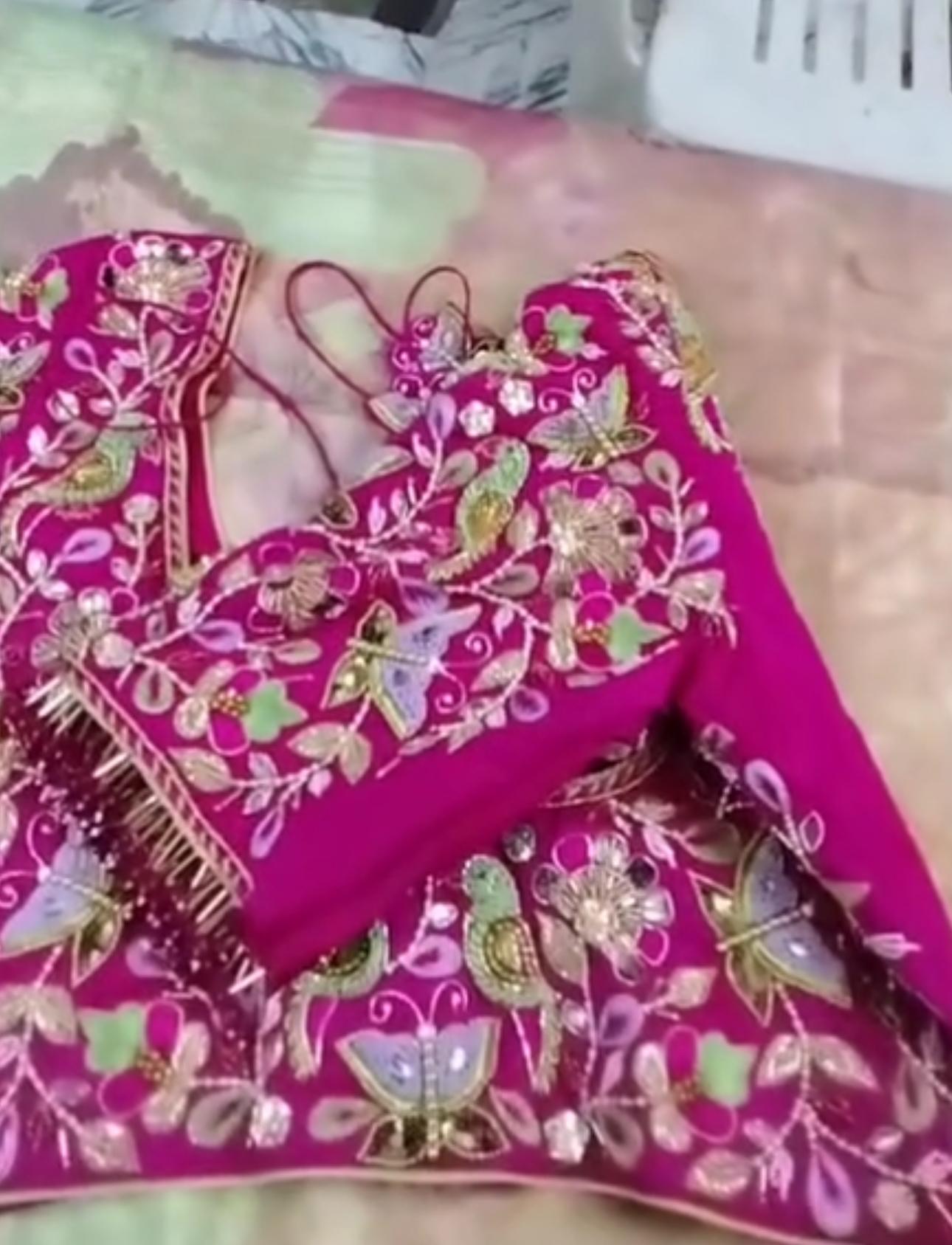 Magenta bridal blouse with elaborate floral maggam work and gold embroidery