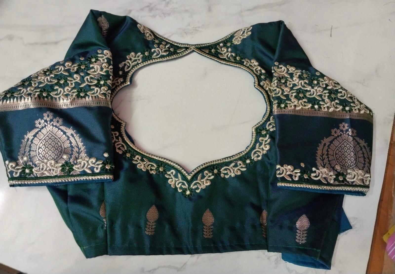 Navy blue bridal blouse with gold zari embroidery and intricate maggam work