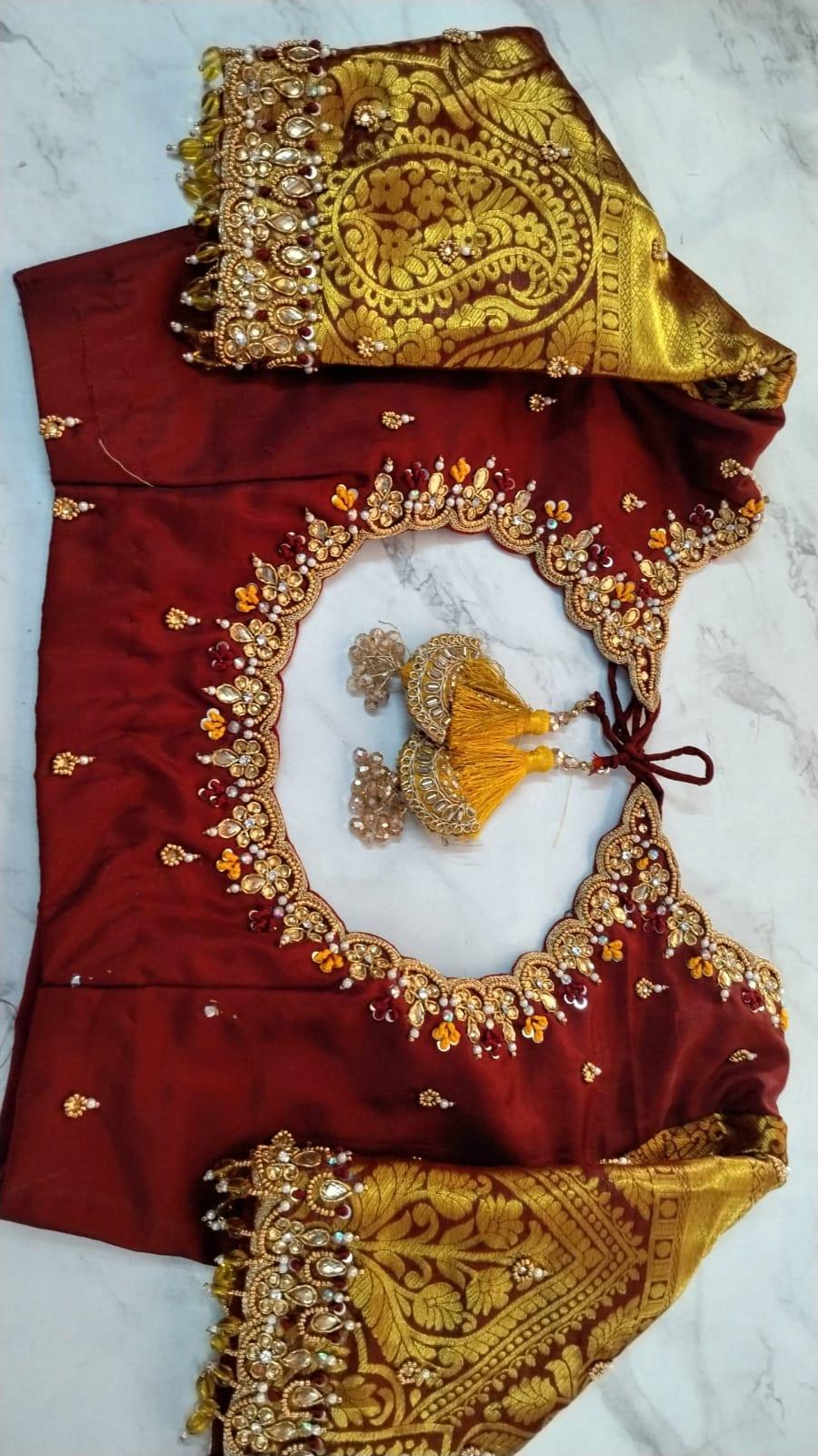 Red silk saree with gold zari embroidery and matching blouse set