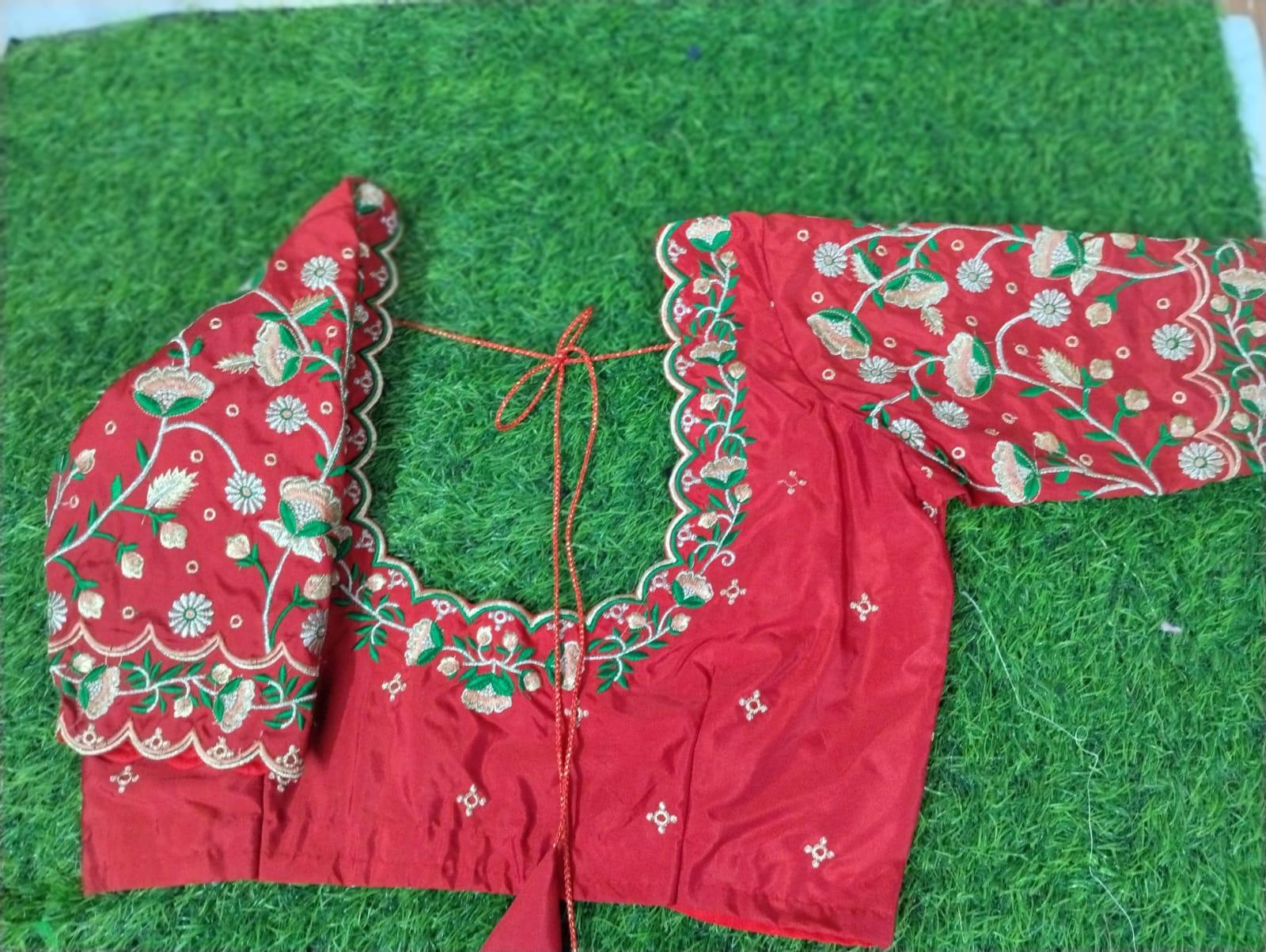 Red bridal blouse with intricate floral zari and gold embroidery work