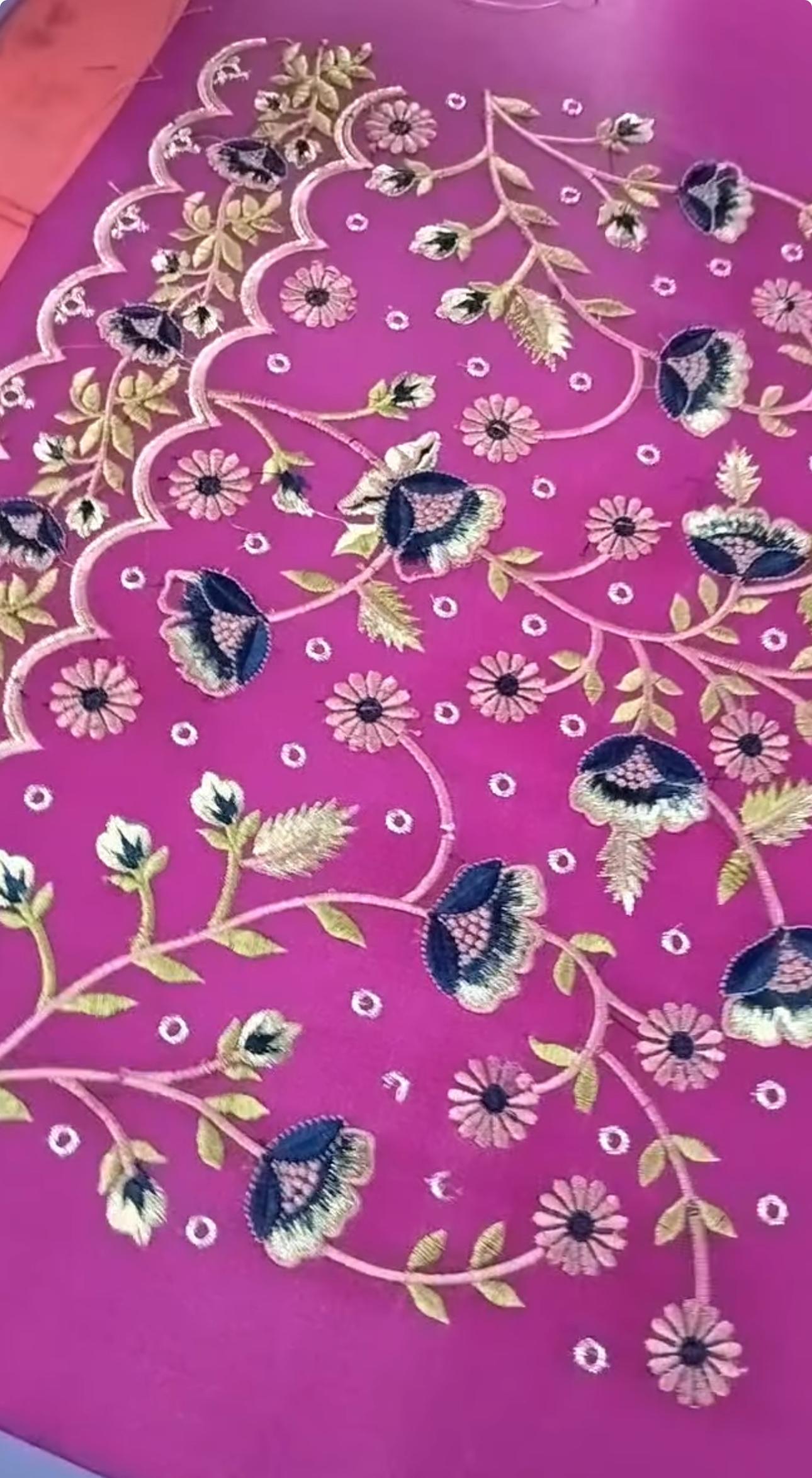 Magenta silk saree with intricate floral embroidery and decorative border