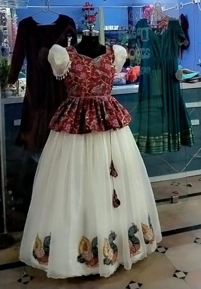 Maroon patterned blouse with cream tulle skirt and embroidered hem