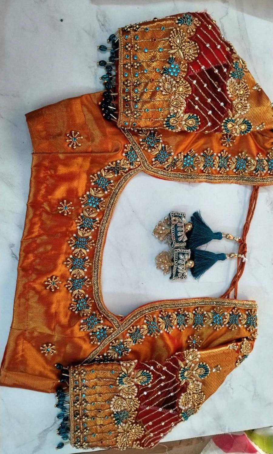 Orange bridal blouse with zari, stone, and maggam embroidery work