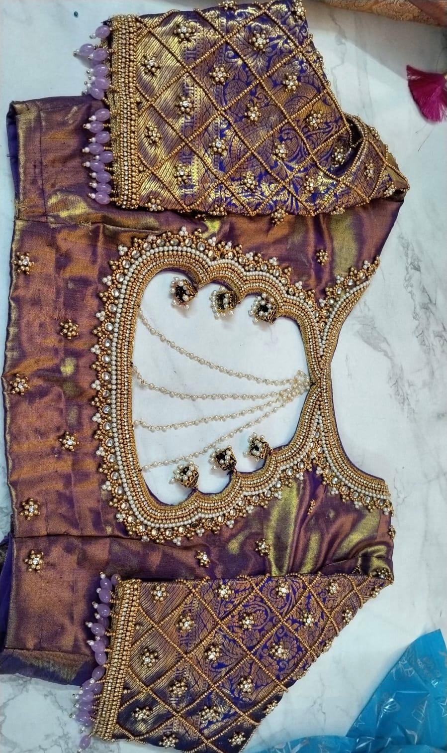 Purple and gold bridal blouse with ornate beadwork and zari embroidery