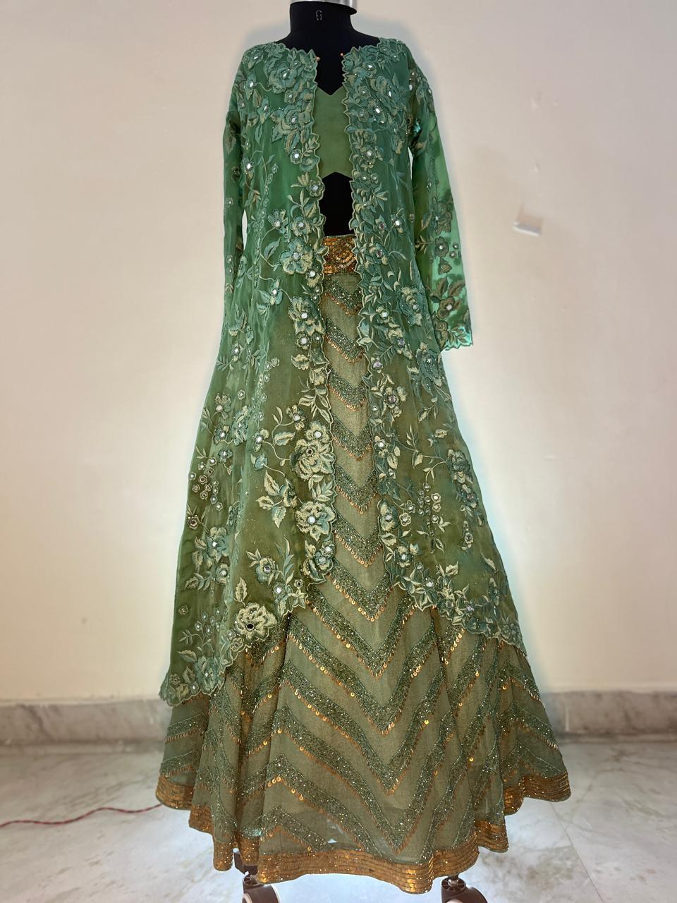 Green lehenga with floral embroidery and gold zari work border