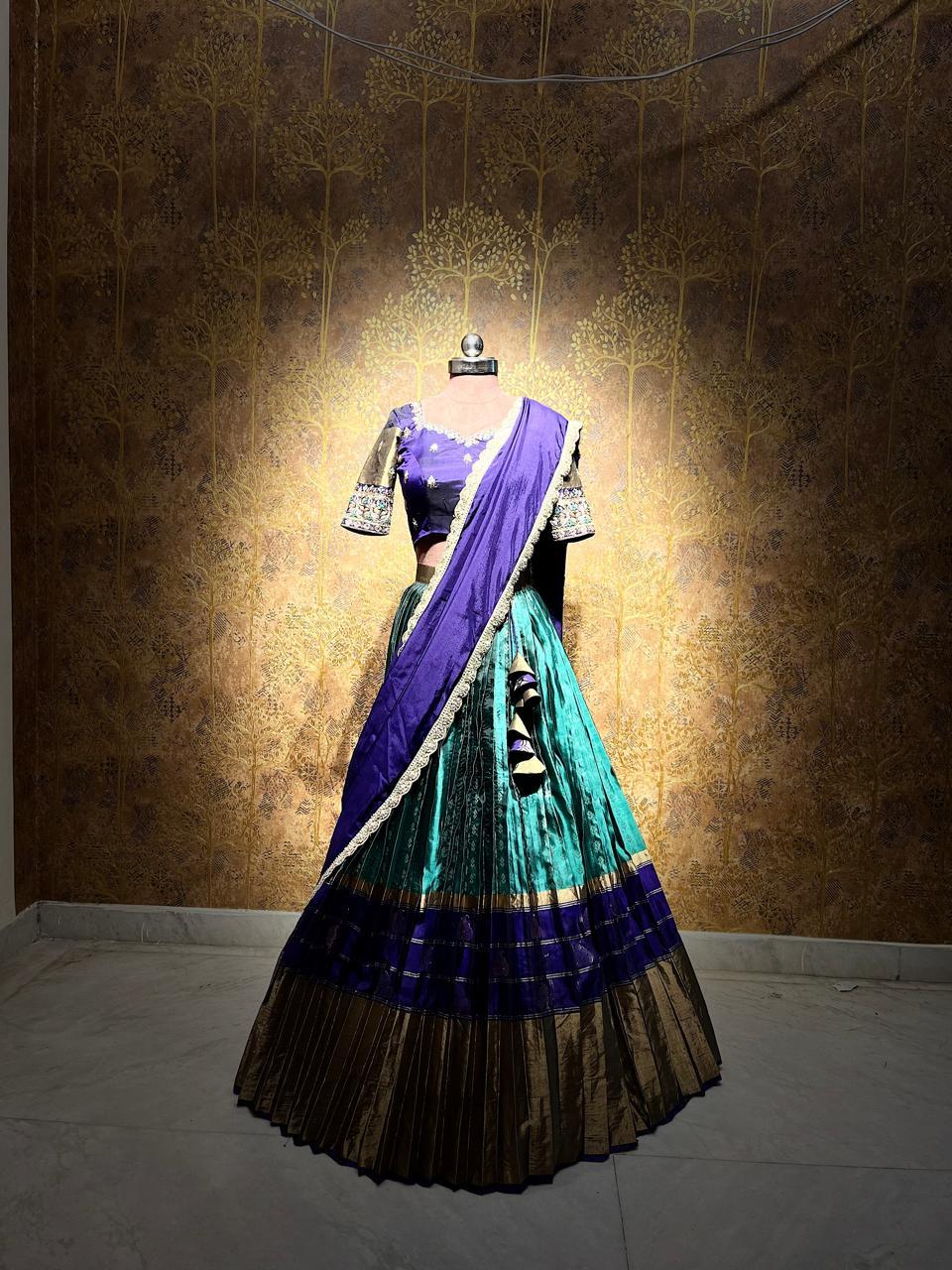 Purple and turquoise pleated saree with black border and ornate blouse