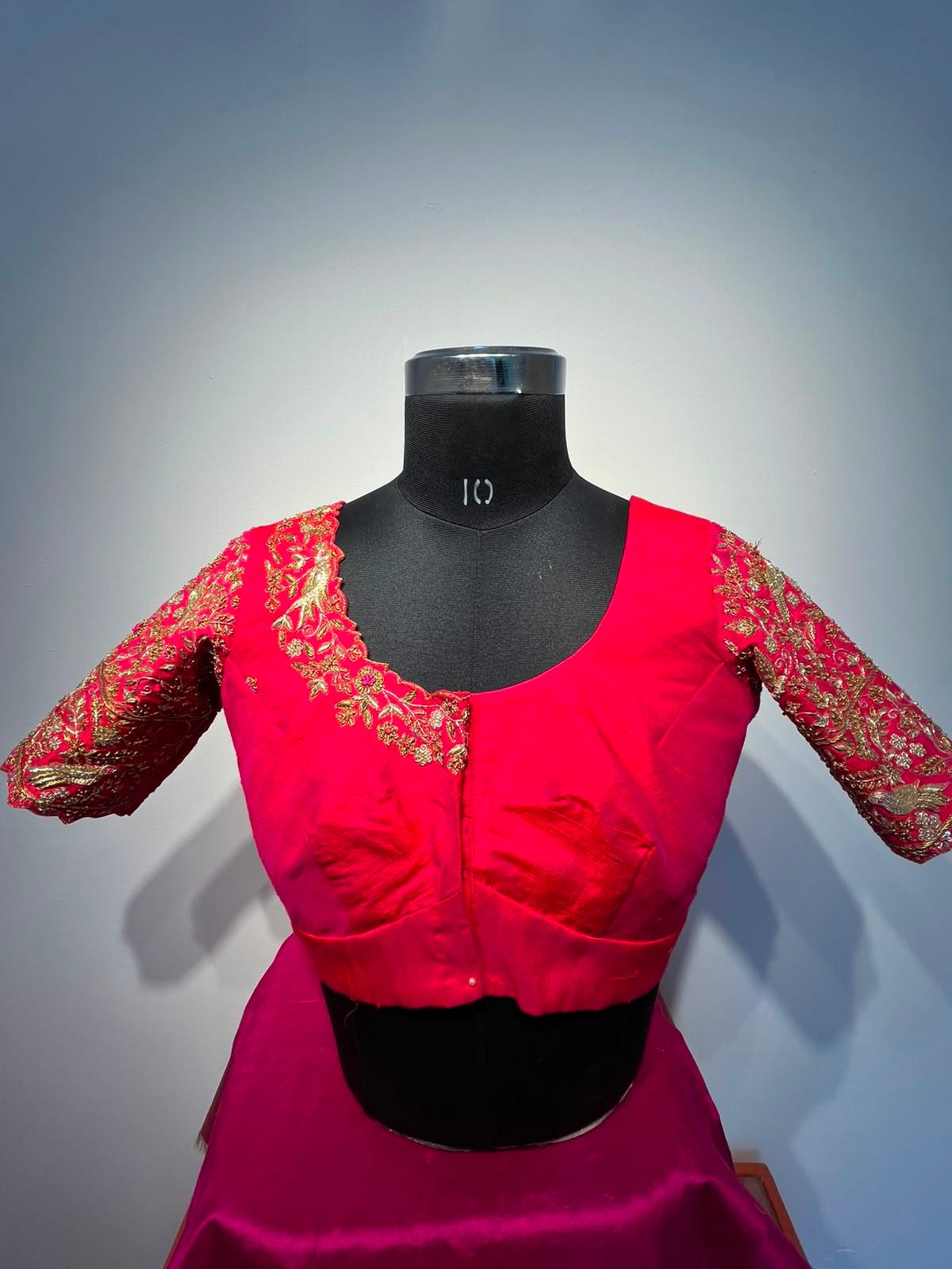 Hot pink bridal blouse with gold zari embroidery sleeves