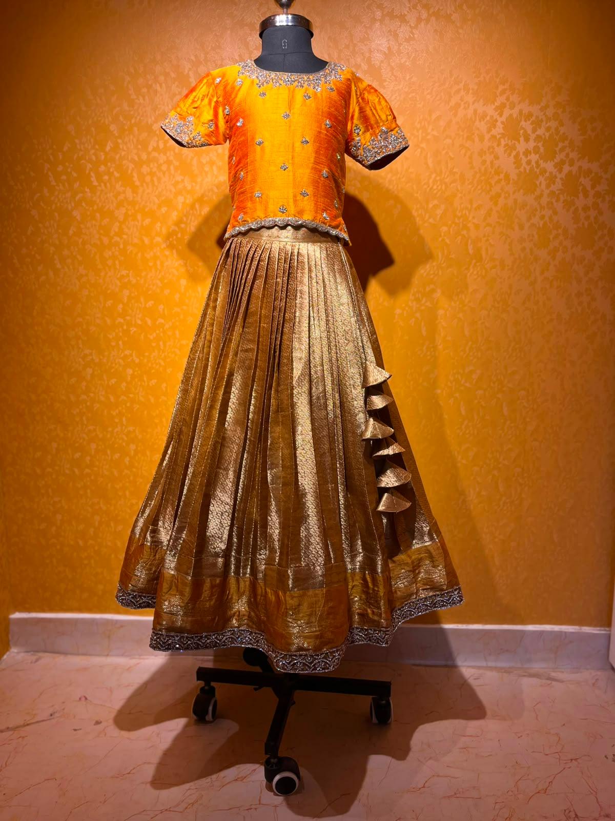 Orange silk blouse with gold embroidered skirt and decorative border