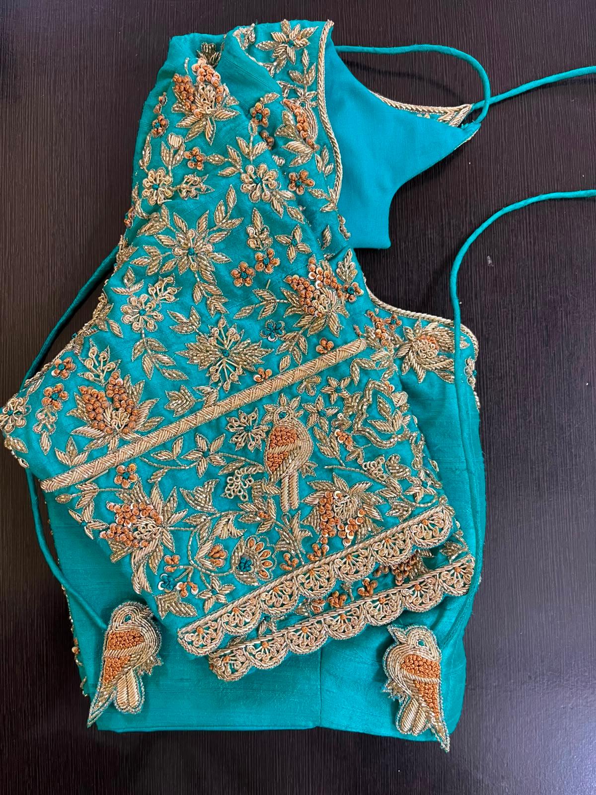 Turquoise bridal blouse with dense gold zari and maggam work embroidery