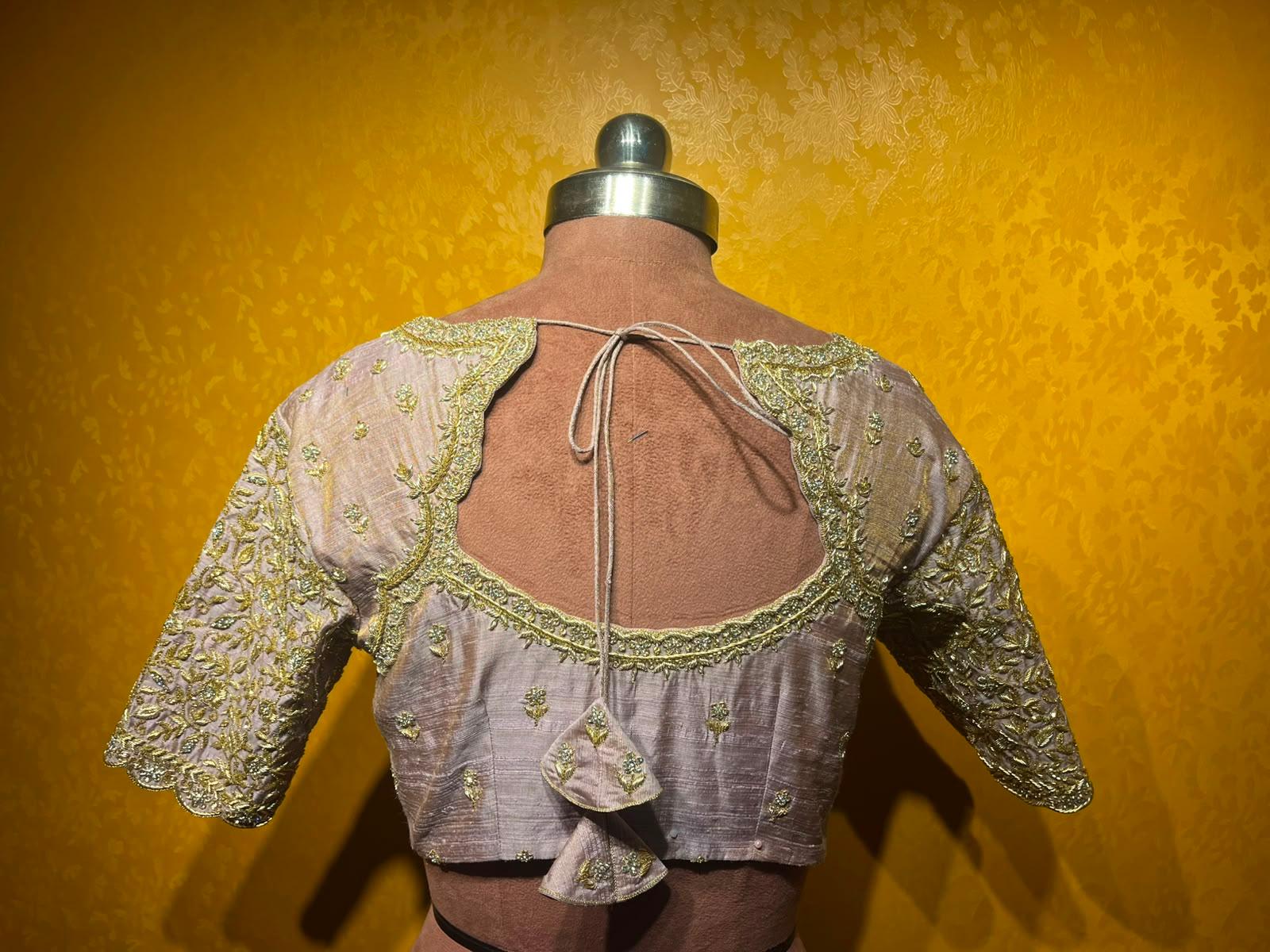 Elegant blouse with gold zari embroidery and cutout back detail