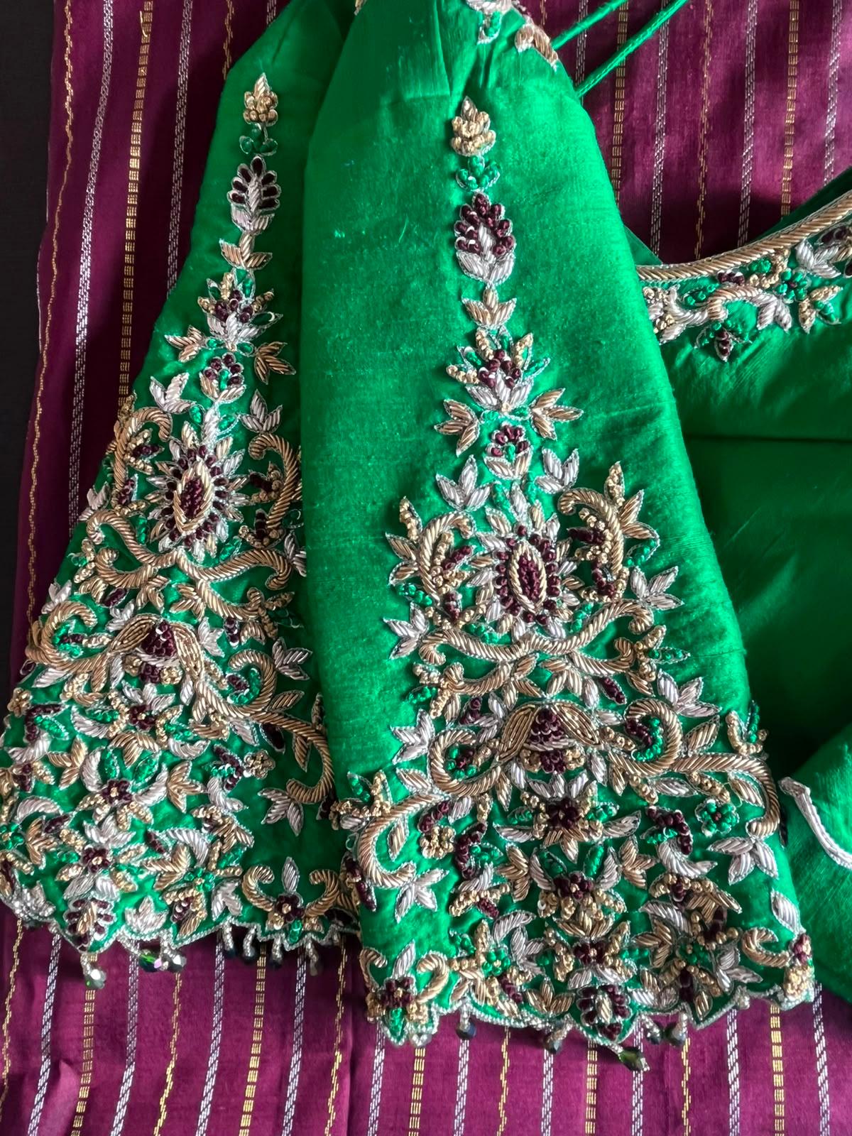 Emerald green blouse with intricate gold and silver floral maggam work