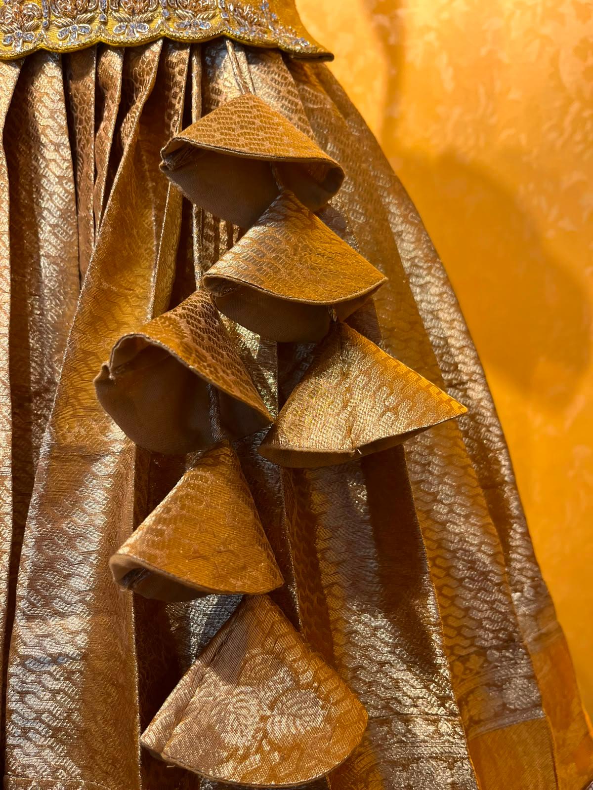 Gold textured saree with dimensional leaf-shaped pleated embellishment detail