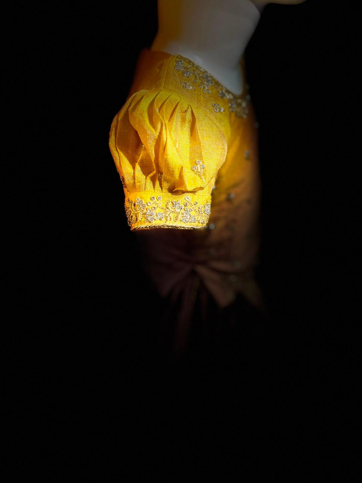 Golden yellow bridal blouse with embellished zari work and pleated design