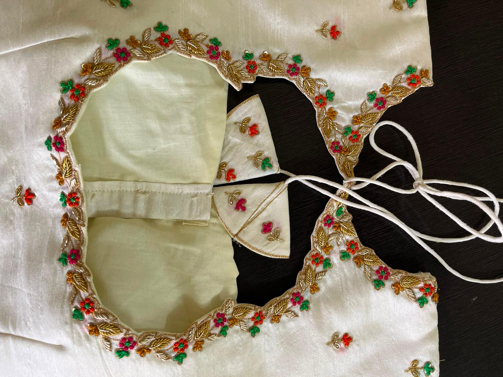 Cream blouse with ornate gold zari and floral embroidery border