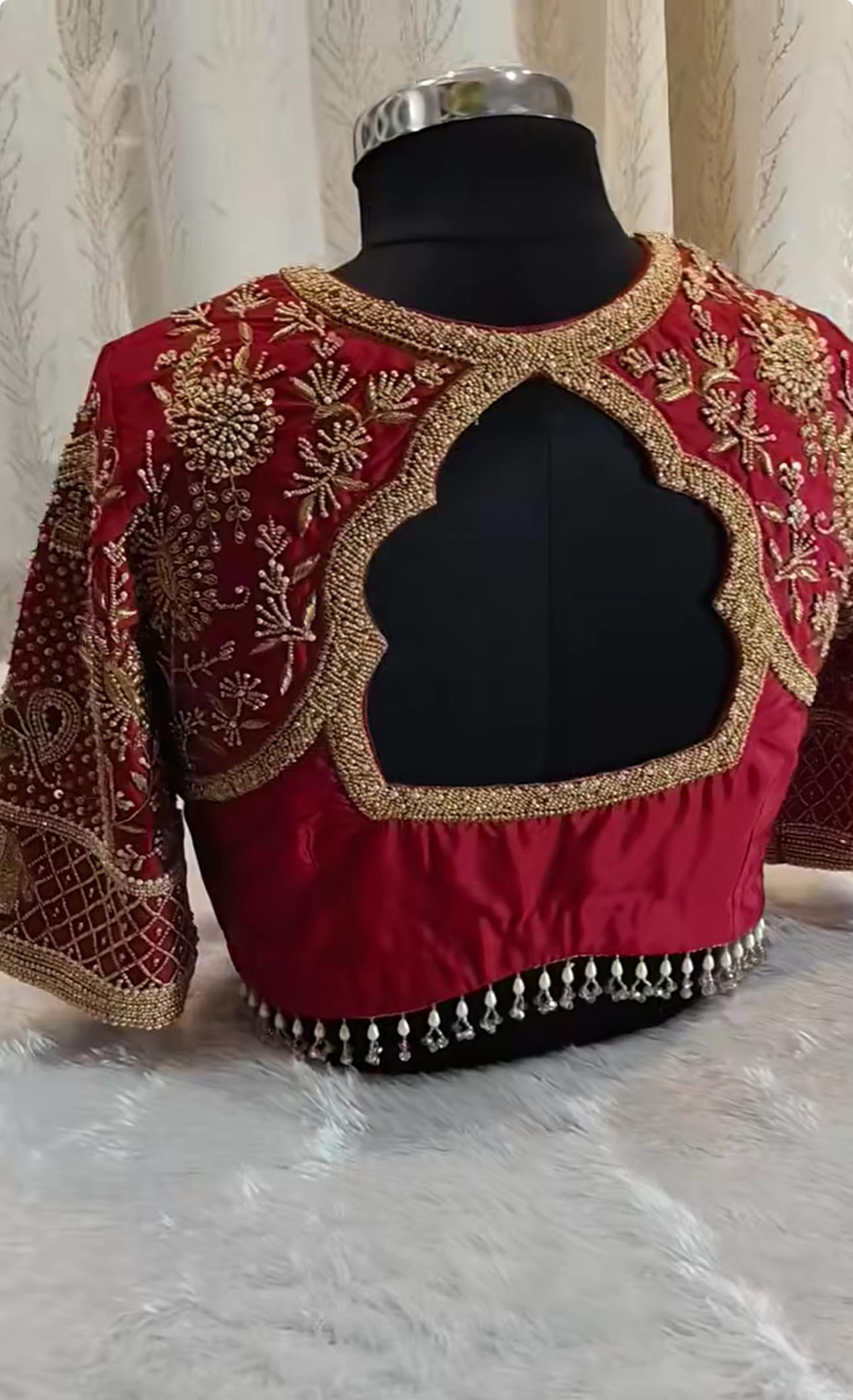 Maroon bridal blouse with gold zari embroidery and pearl beading