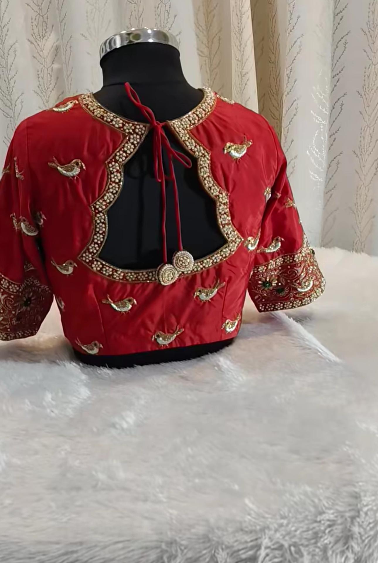 Red velvet bridal blouse with gold zari embroidery and pearl beading