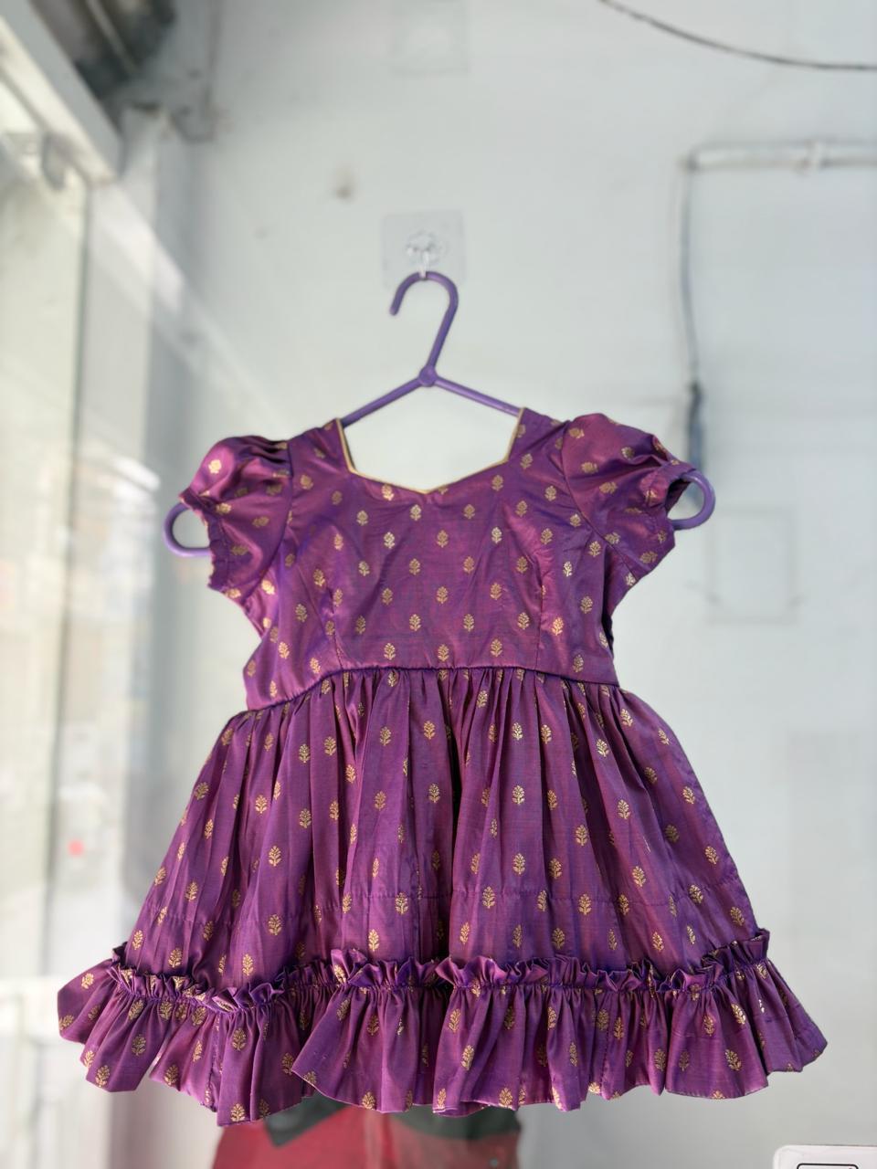 Purple silk frock with gold zari motifs and ruffled hem