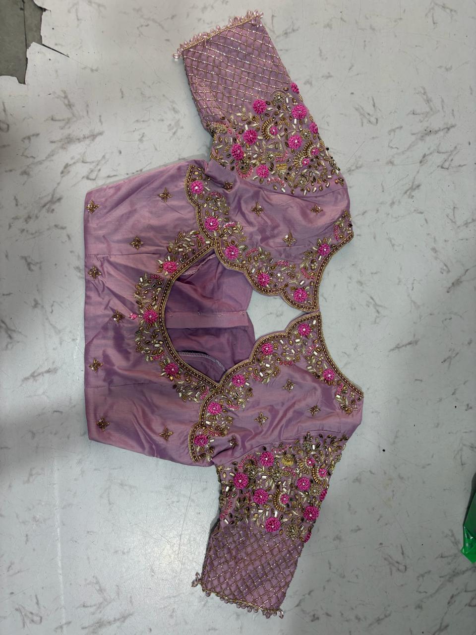 Lavender bridal blouse with ornate maggam work and pink floral embroidery