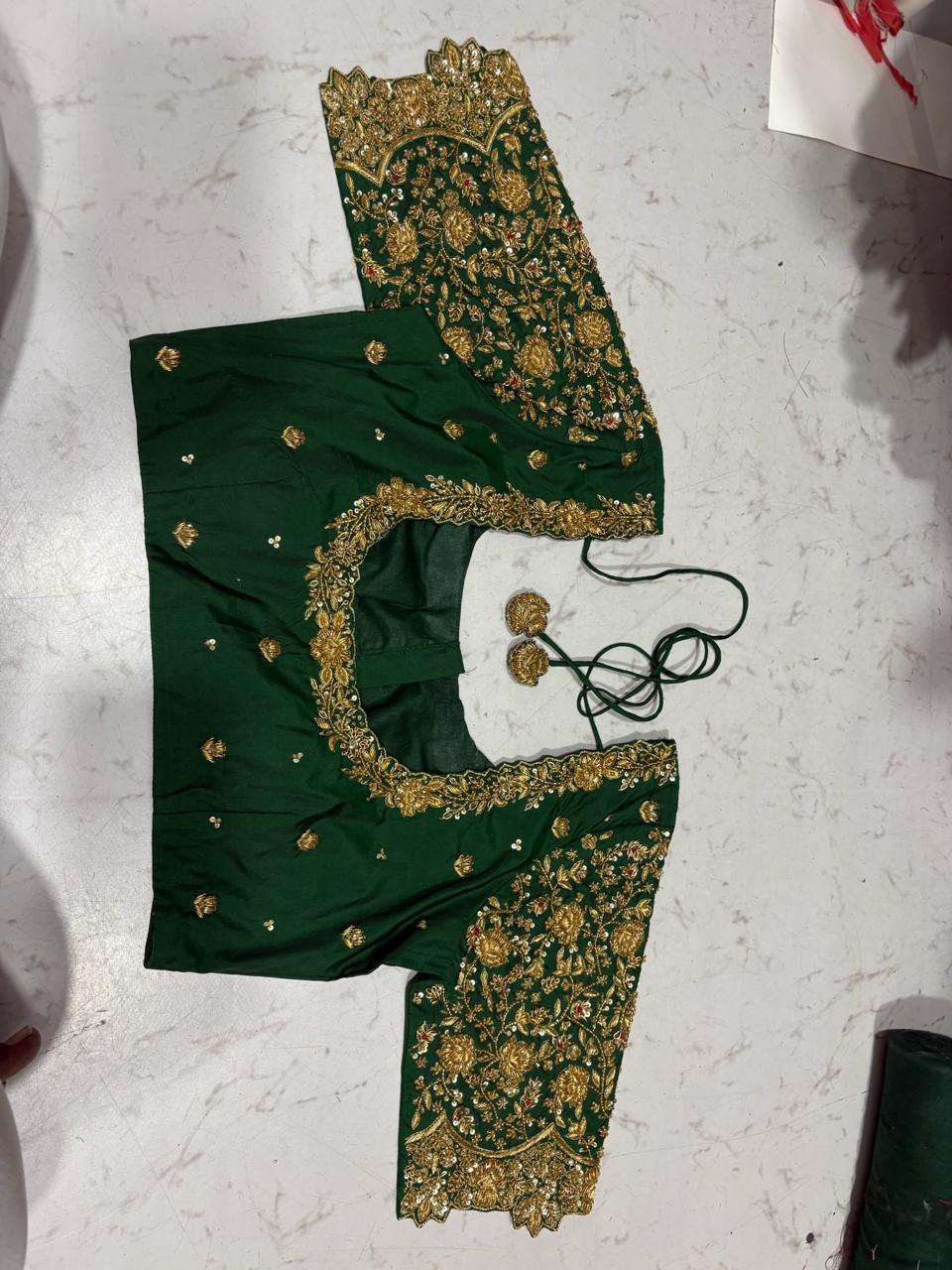 Green silk saree with gold zari embroidery and ornate borders
