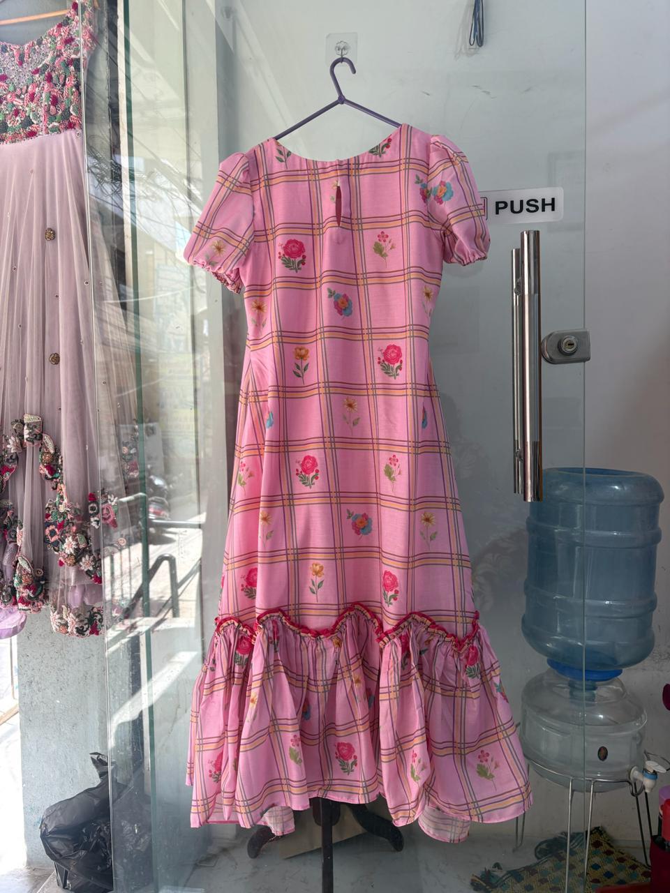Pink floral checkered dress with ruched hemline and puff sleeves