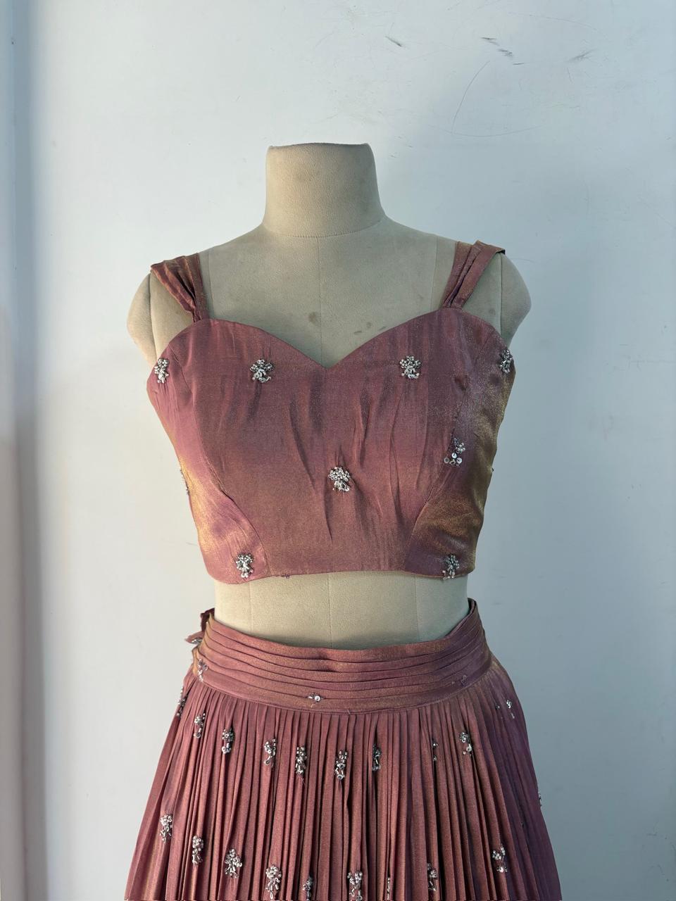Mauve crop blouse with scattered rhinestone embellishments and pleated skirt