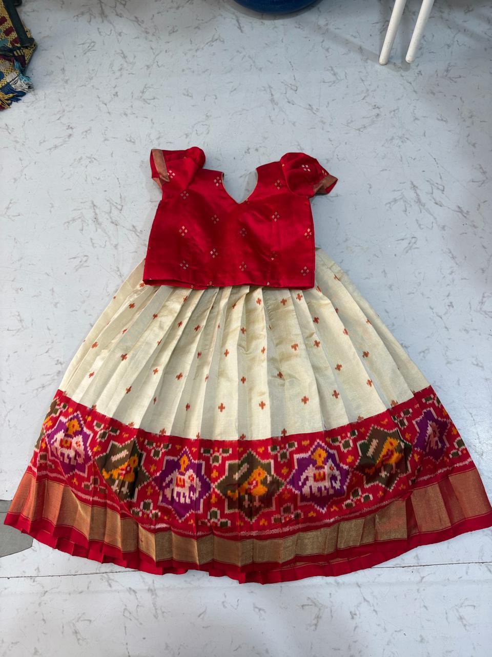 Red and cream traditional girls dress with ikat border and embroidery