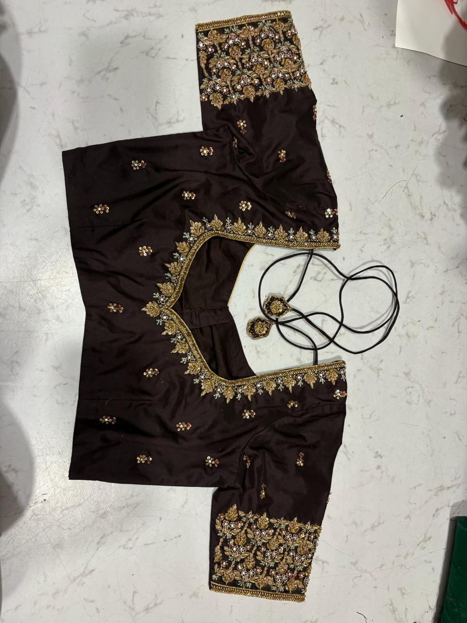 Black blouse with gold zari embroidery and floral maggam work borders