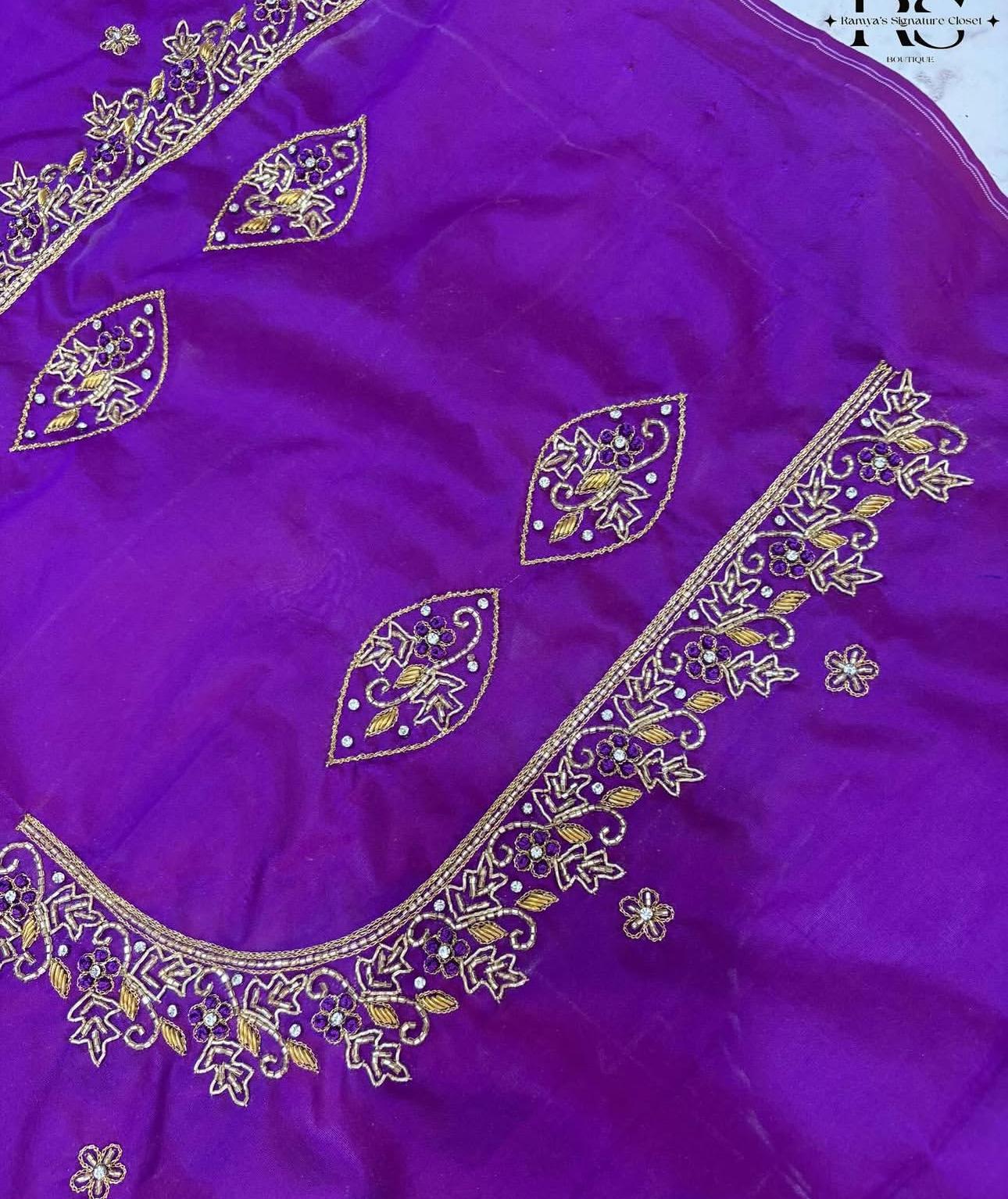 Purple silk saree with ornate gold zari embroidery and floral patterns