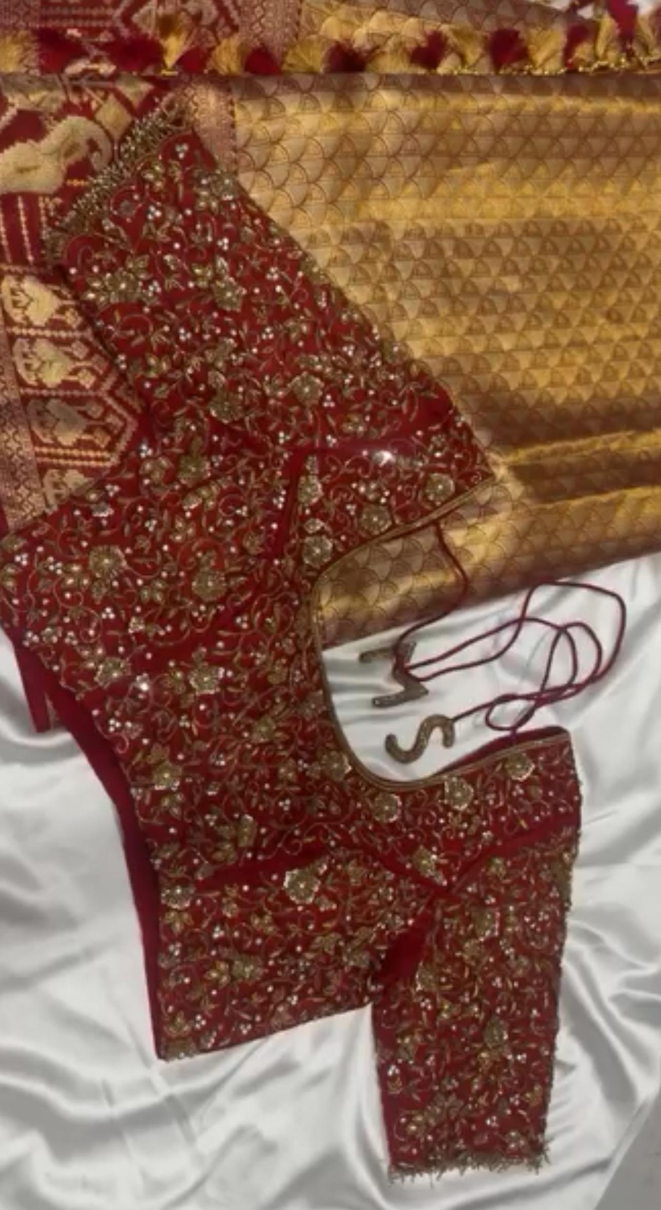 Maroon bridal blouse with dense gold zari and maggam embroidery work
