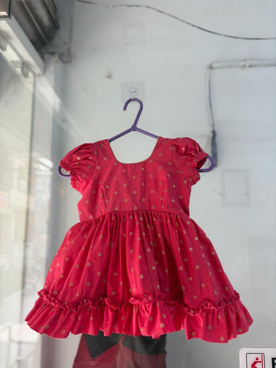Red silk frock with gold brocade pattern and ruffle hem