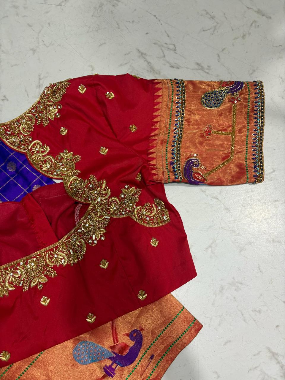 Red bridal blouse with gold zari embroidery and ornate borders
