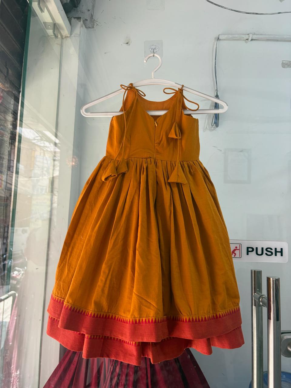 Golden yellow girls traditional dress with red border trim