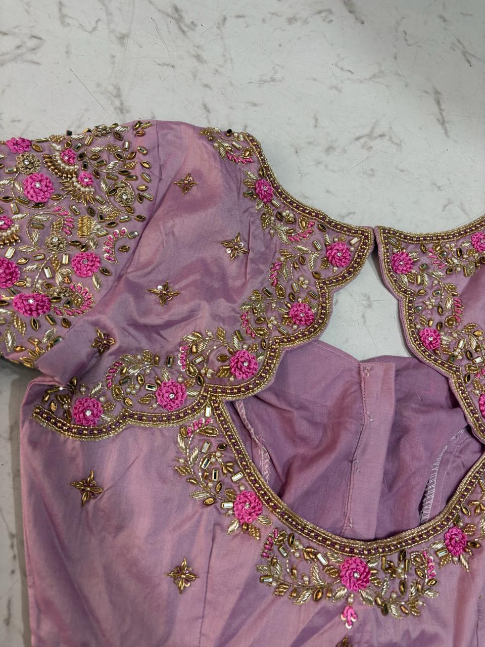 Lavender bridal blouse with pink floral maggam work and gold embroidery